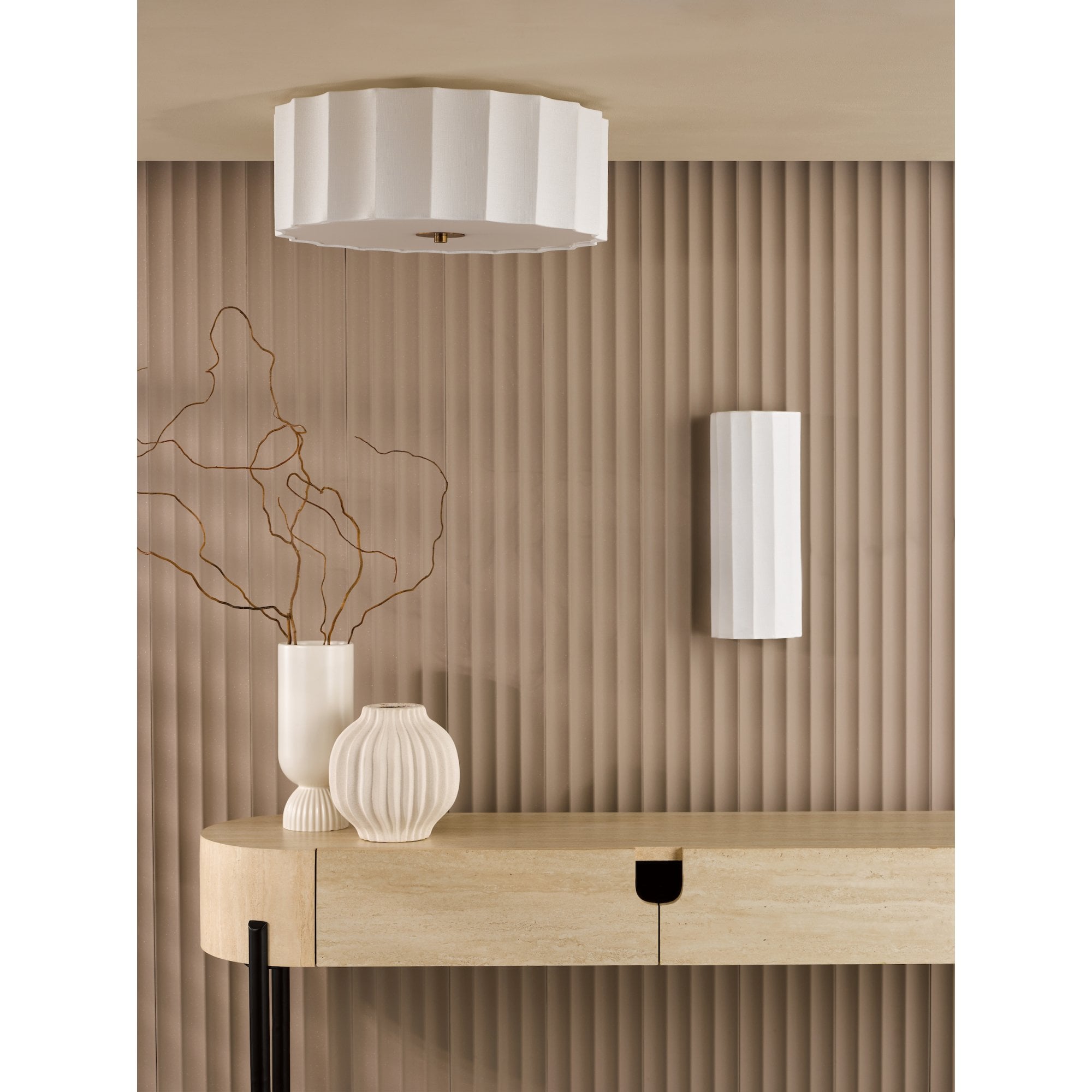 A modern entryway featuring a fluted white ceiling light and matching wall light.