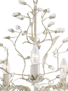 Close-up of the white and crystal chandelier, highlighting its intricate details.