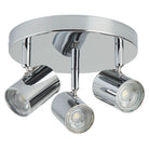 A shiny chrome ceiling light with three adjustable spotlights providing illumination.