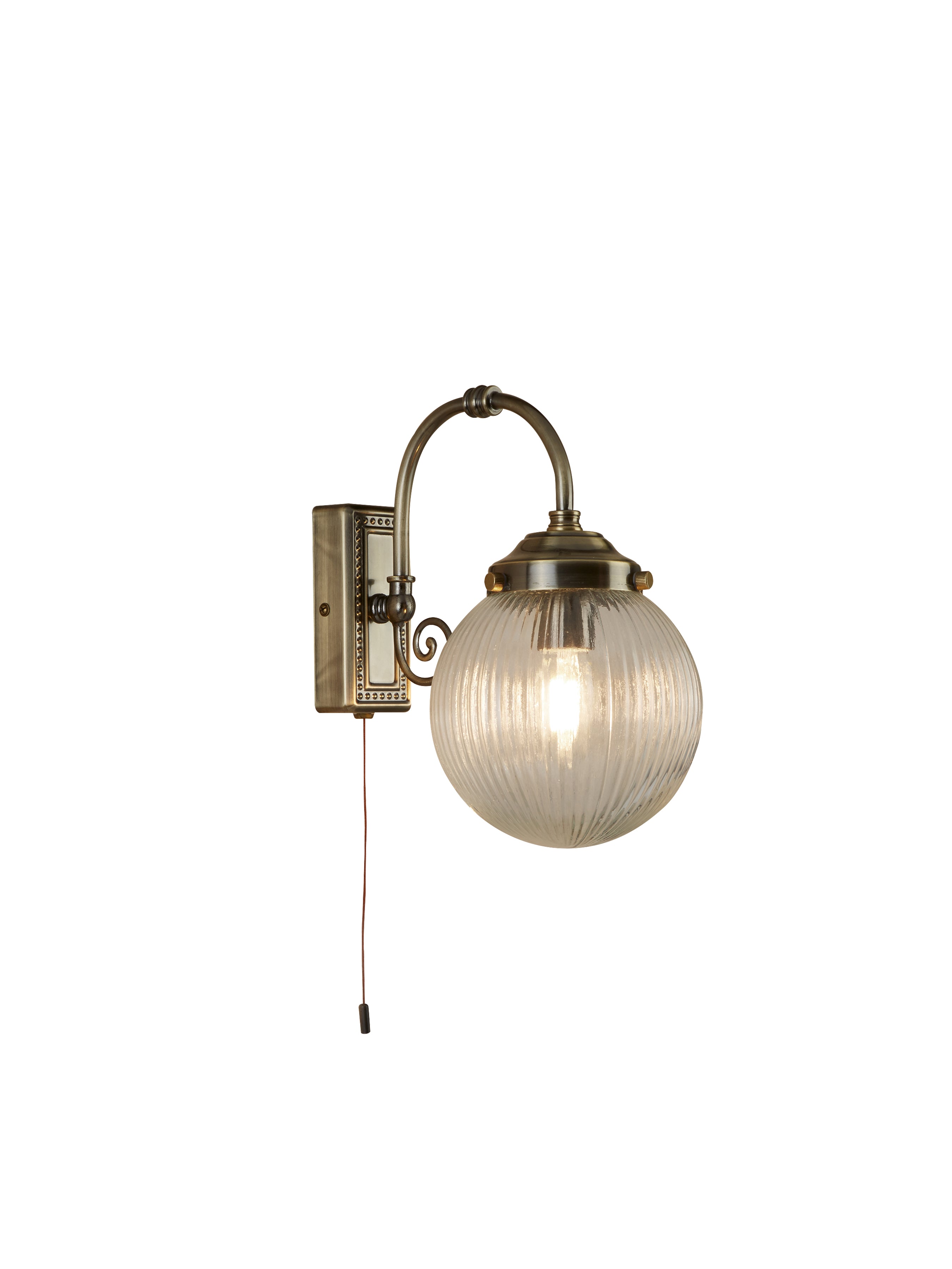 Vintage brass wall light with a ribbed glass globe and pull cord switch.