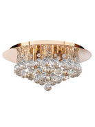 An ornate flush mount ceiling light featuring a gold base and multiple clear crystal spheres.