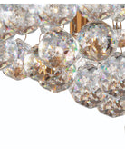 A close-up view of the glittering faceted crystal balls on a ceiling light fixture.