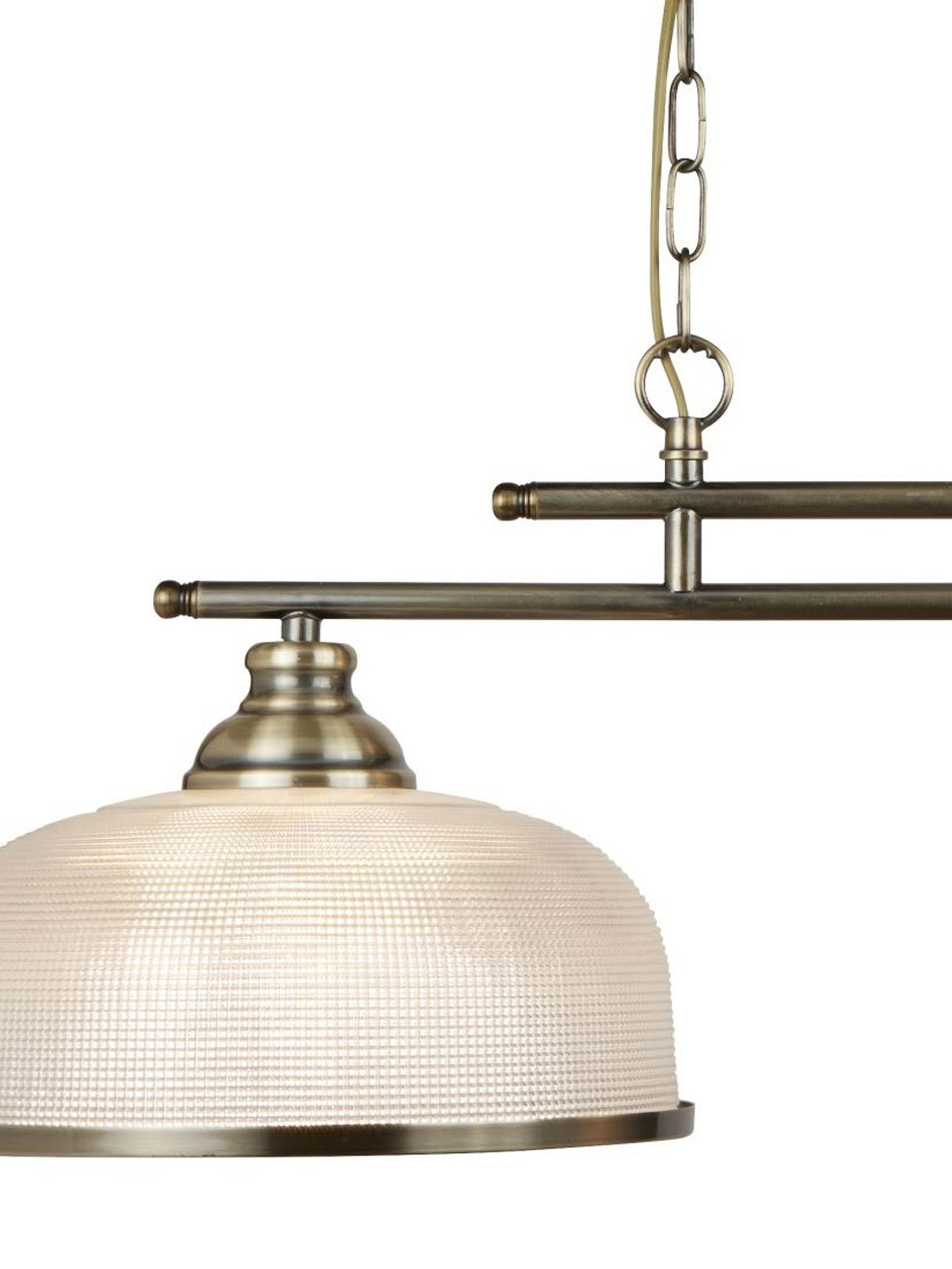 A close-up of a brass light fixture with a textured white dome shade.