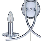Close-up of a chrome wall light with a candle-style bulb and clear base.