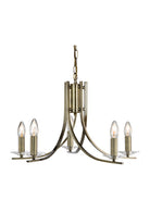 An antique brass chandelier with five lights, clear glass accents, and a central column.