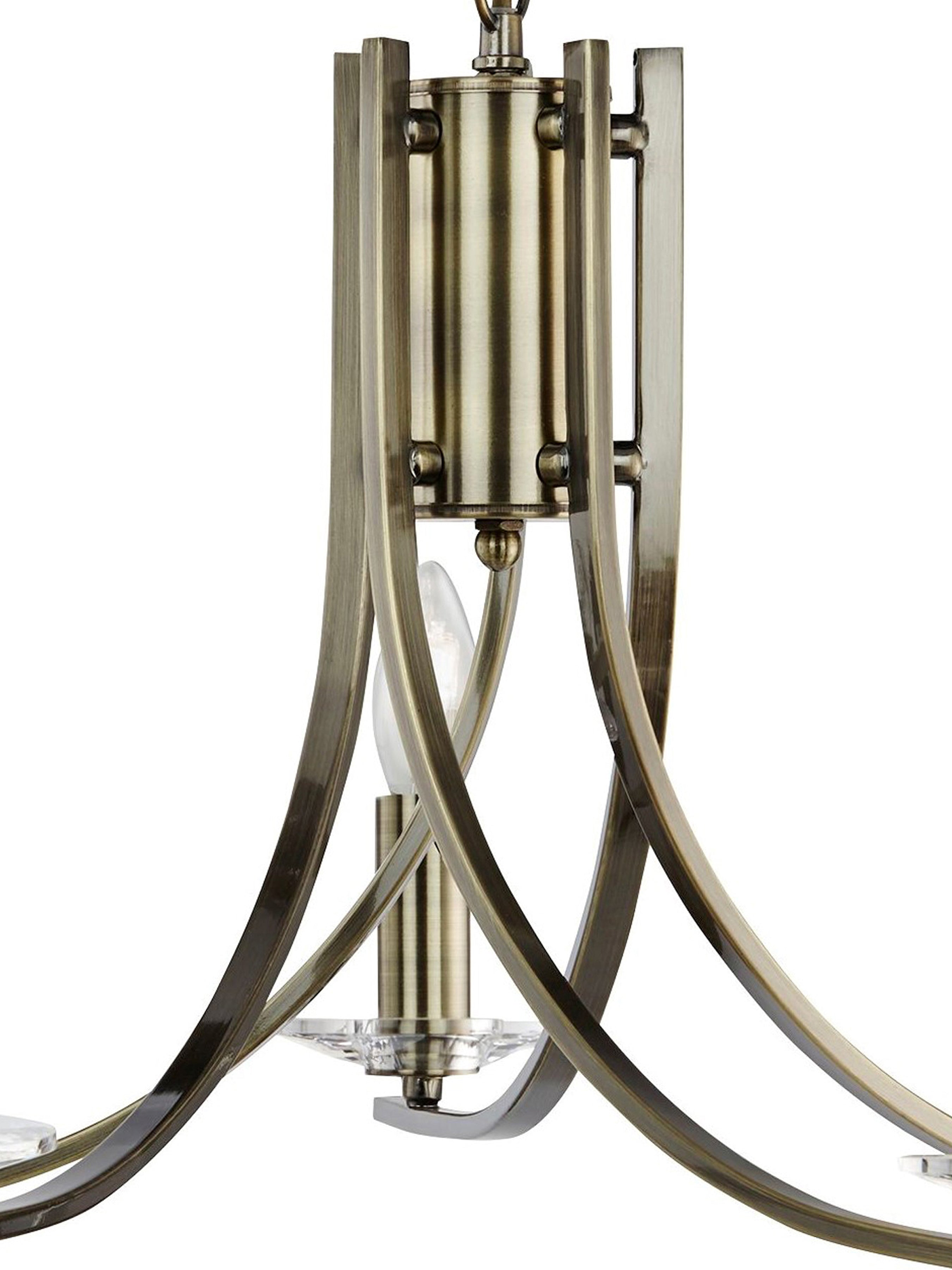 A close-up of the antique brass chandelier's central column and a single light with clear glass.