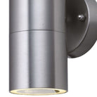 Close-up of a modern, cylindrical brushed steel outdoor wall light with a downward beam.