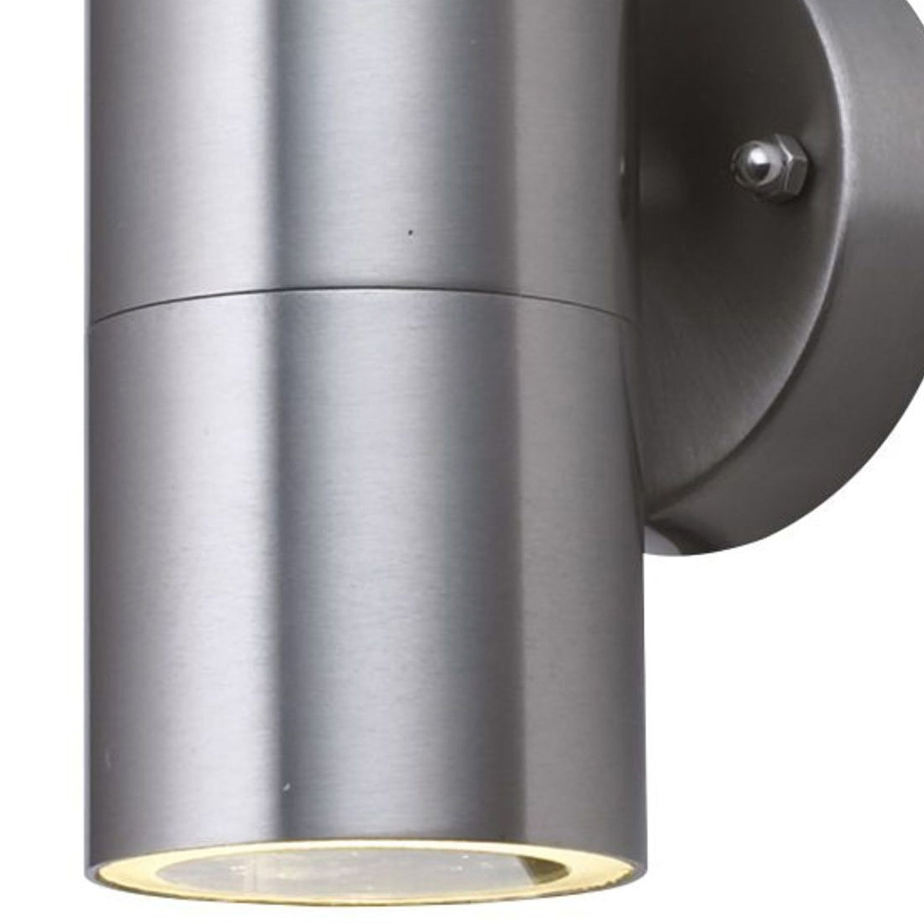 Close-up of a modern, cylindrical brushed steel outdoor wall light with a downward beam.