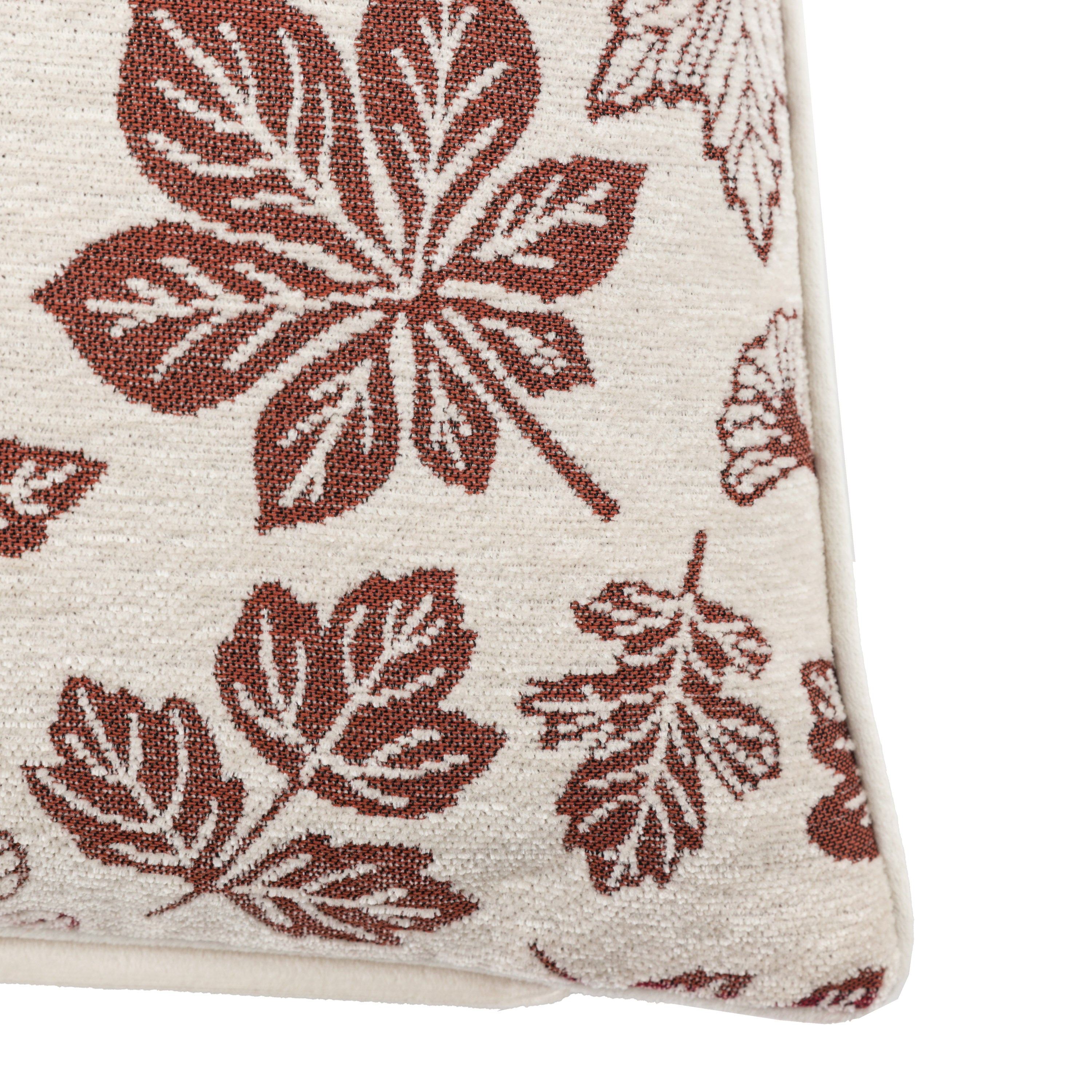 A close-up of a cushion with autumn leaf patterns, highlighting the texture and design.