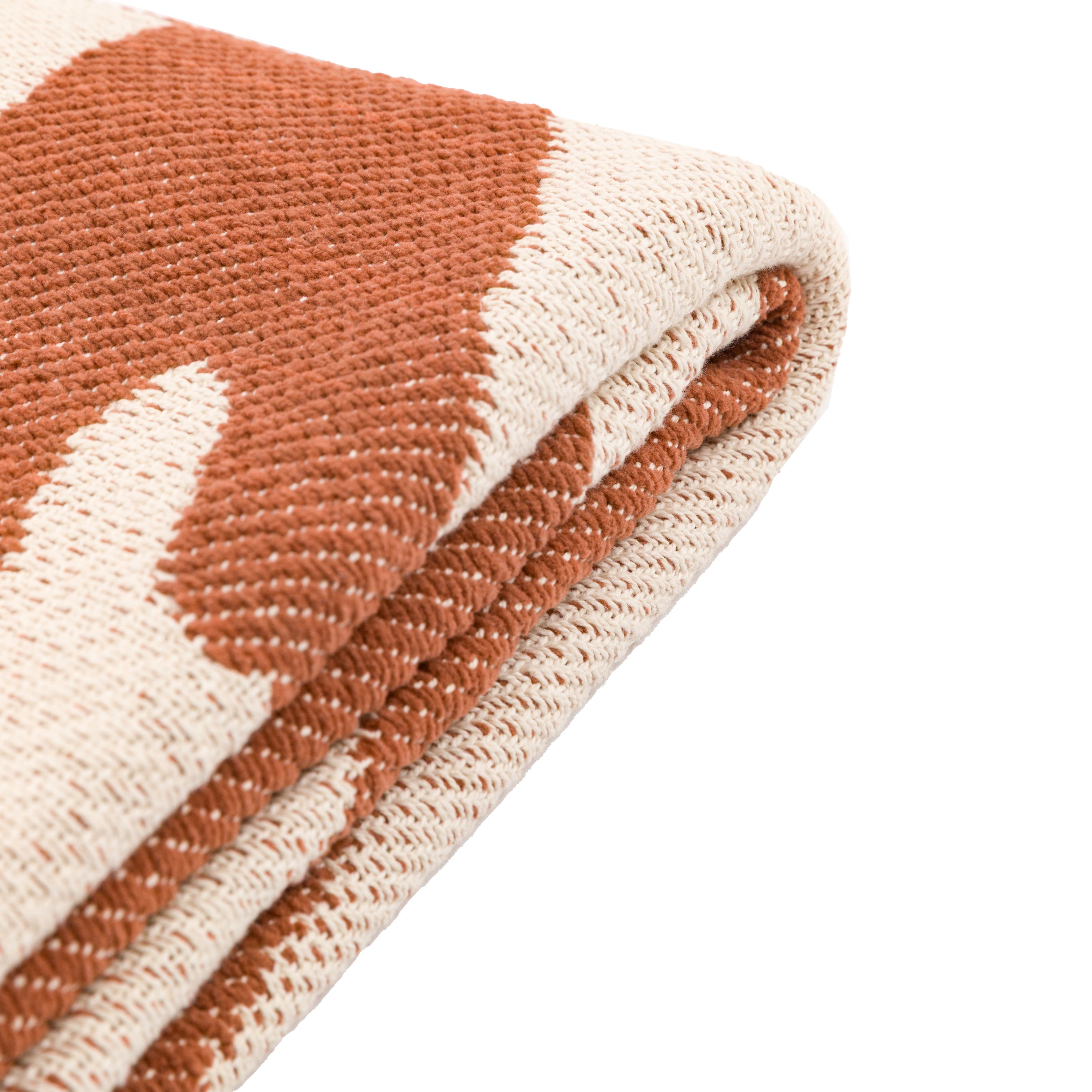 Folded boho throw blanket showing the burnt orange and off-white abstract pattern detail.