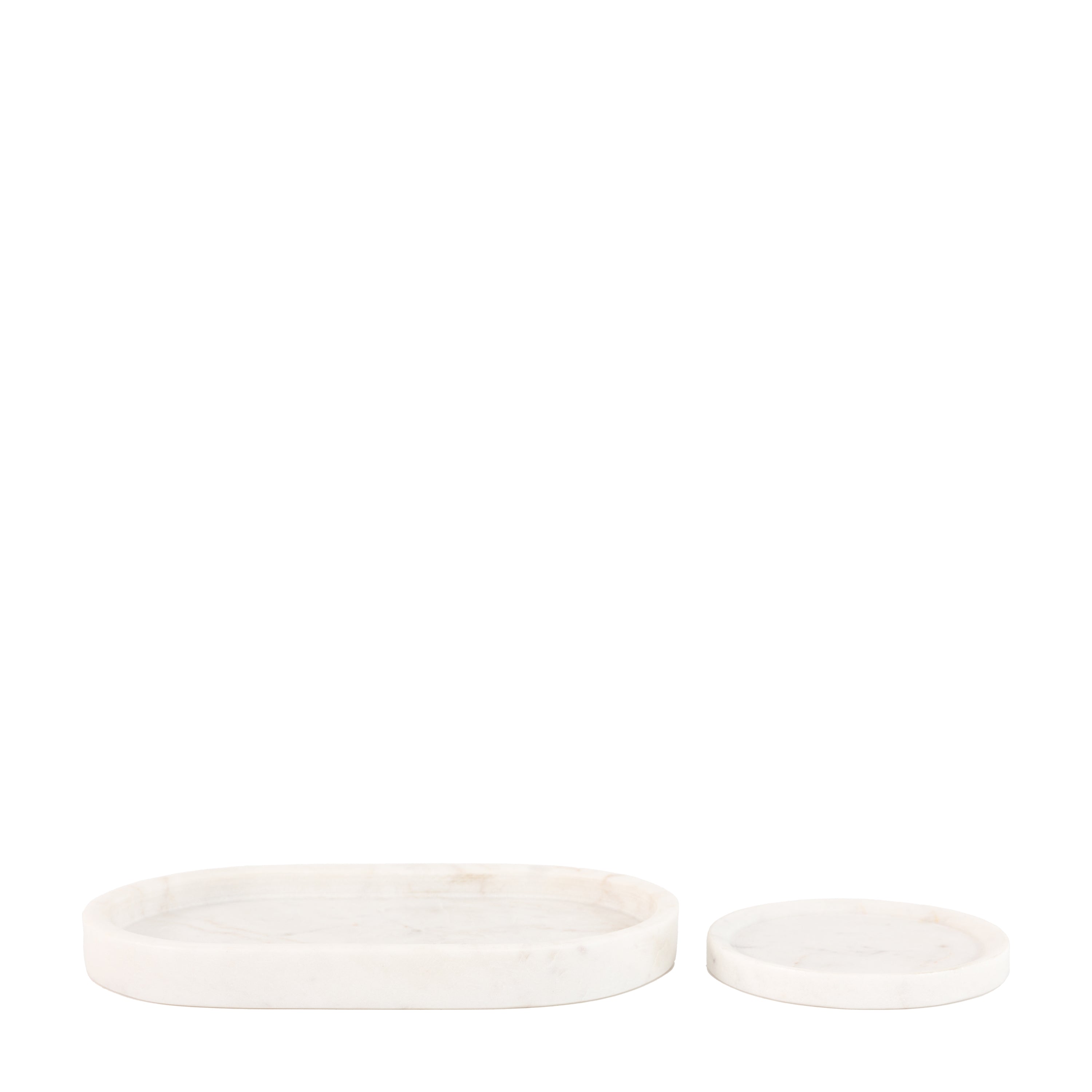 Two white marble trays, one oval and one round, on a white background.
