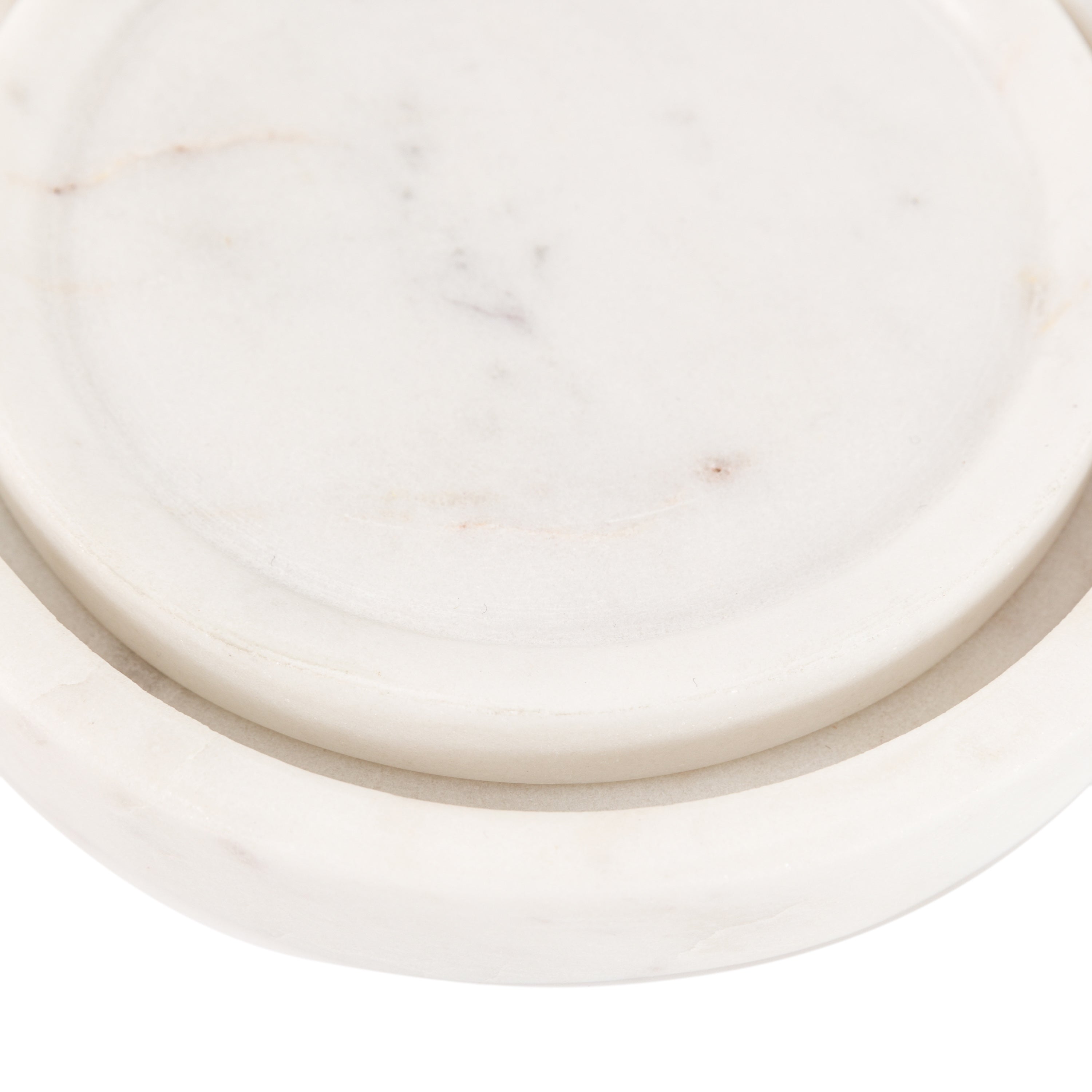 Close-up of the two nested white marble trays on a white background.