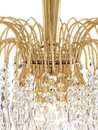 Close-up of the chandelier's intricate gold frame and sparkling crystal details.
