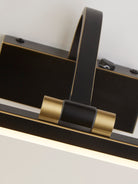 Close-up of the black and gold picture light with an illuminated bar.
