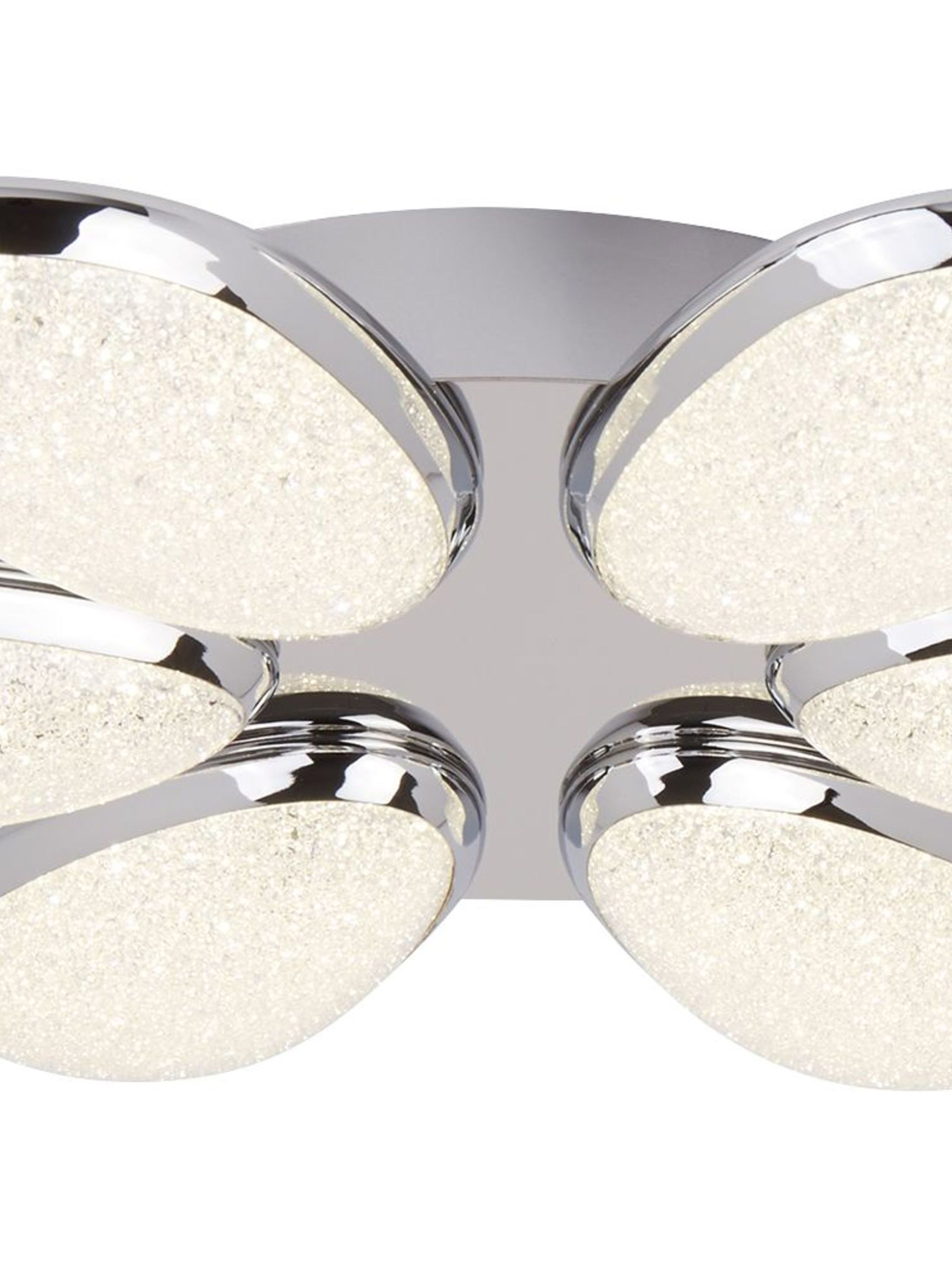 A close-up of a contemporary chrome ceiling light with six textured LED panels.