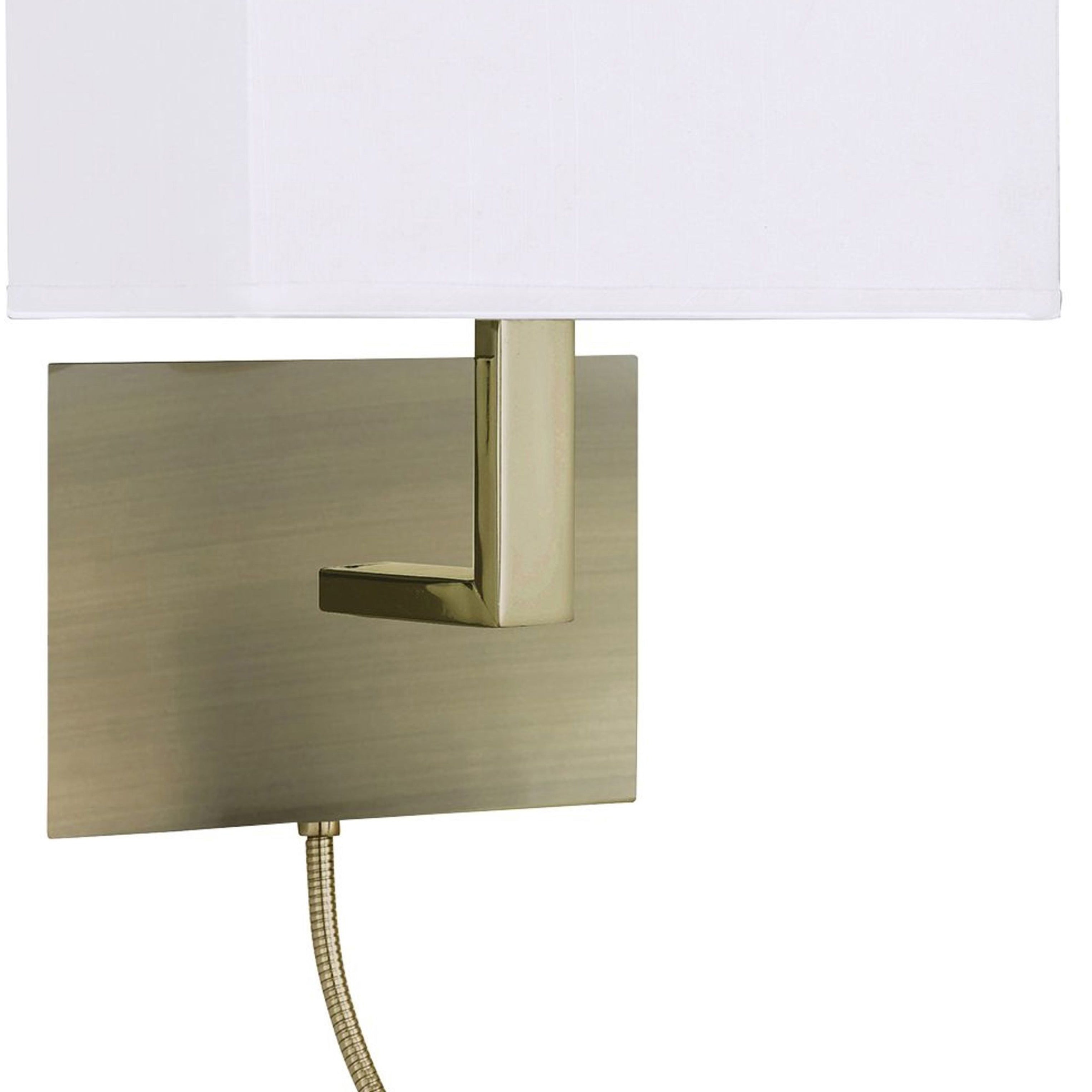 A close-up of a modern brass wall light with a white rectangular shade and a reading arm.