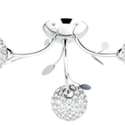 Close-up of a chrome ceiling light with crystal orb shades and decorative leaves.