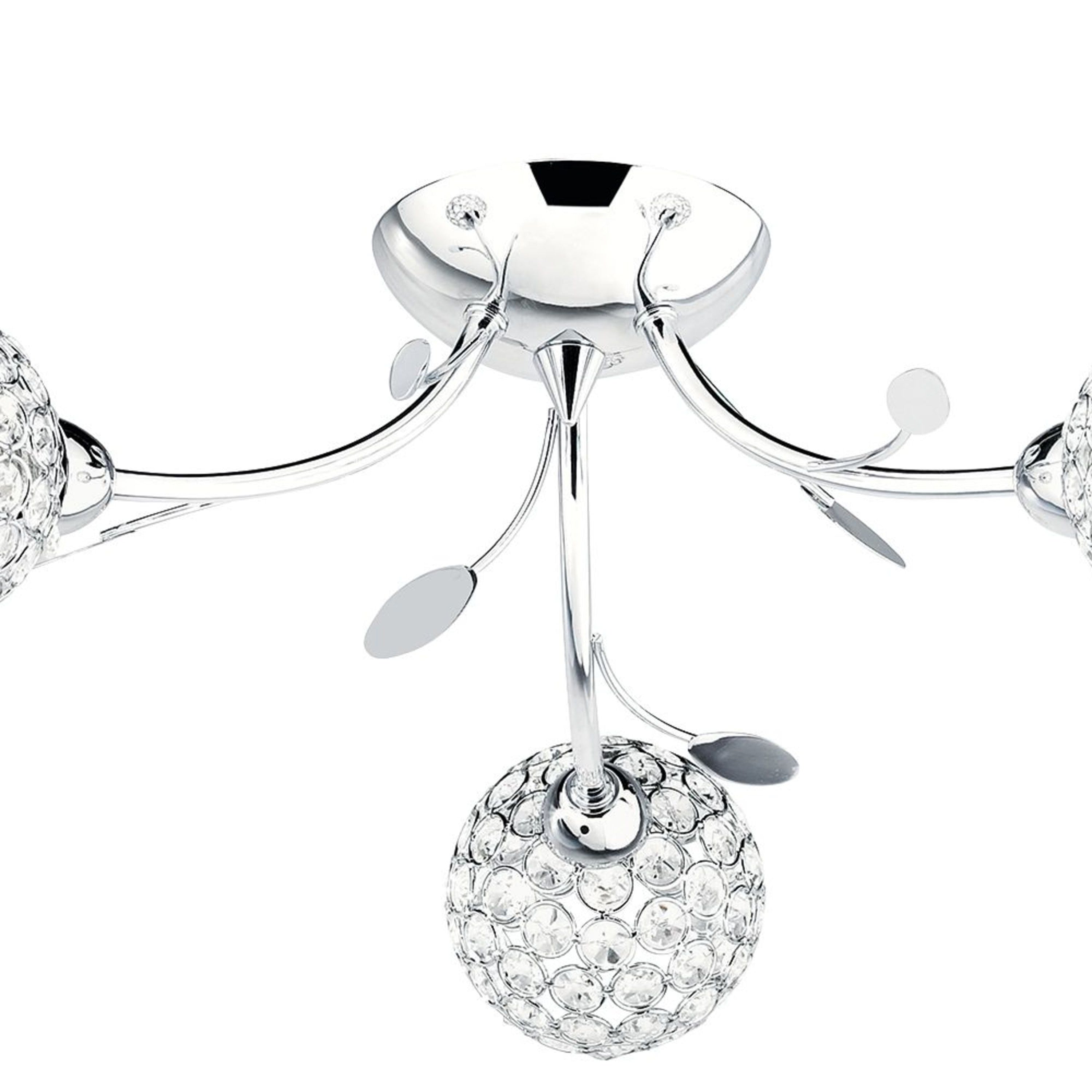 Close-up of a chrome ceiling light with crystal orb shades and decorative leaves.