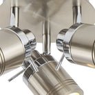 A close-up of four unlit ceiling spotlights in a brushed steel finish.
