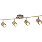 Four antique brass finish track lights with illuminated bulbs on a white background.