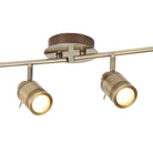 Two antique brass finish track lights with illuminated bulbs against a white background.