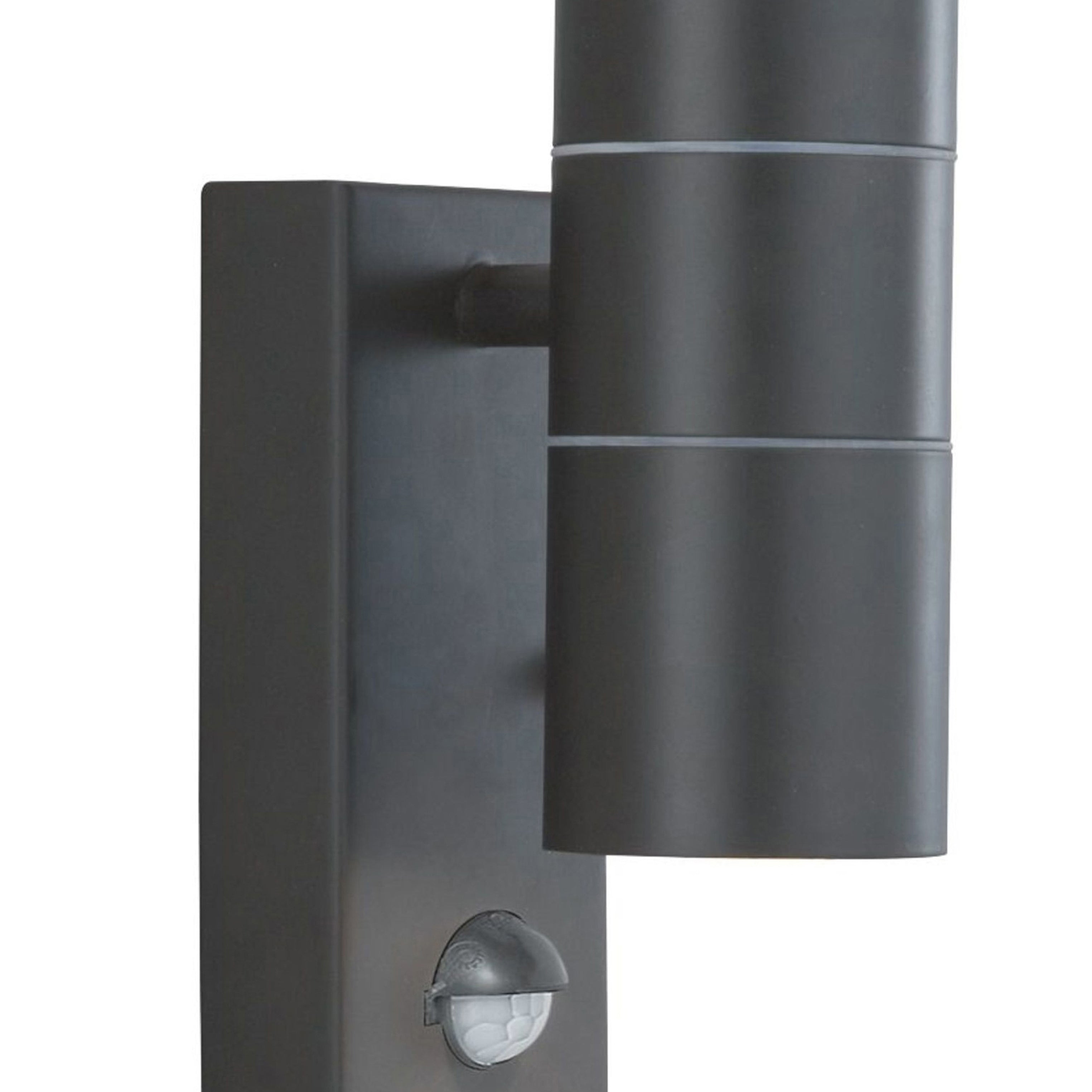 A close-up of a black outdoor wall light with two cylindrical lights and a small sensor.
