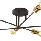A close-up view of the central black base and gold-accented arms of a ceiling light.