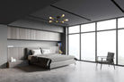 A modern bedroom with gray walls, a large window, and a sputnik ceiling light.