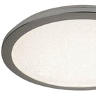 Close-up of a round ceiling light with a silver rim and textured white diffuser.