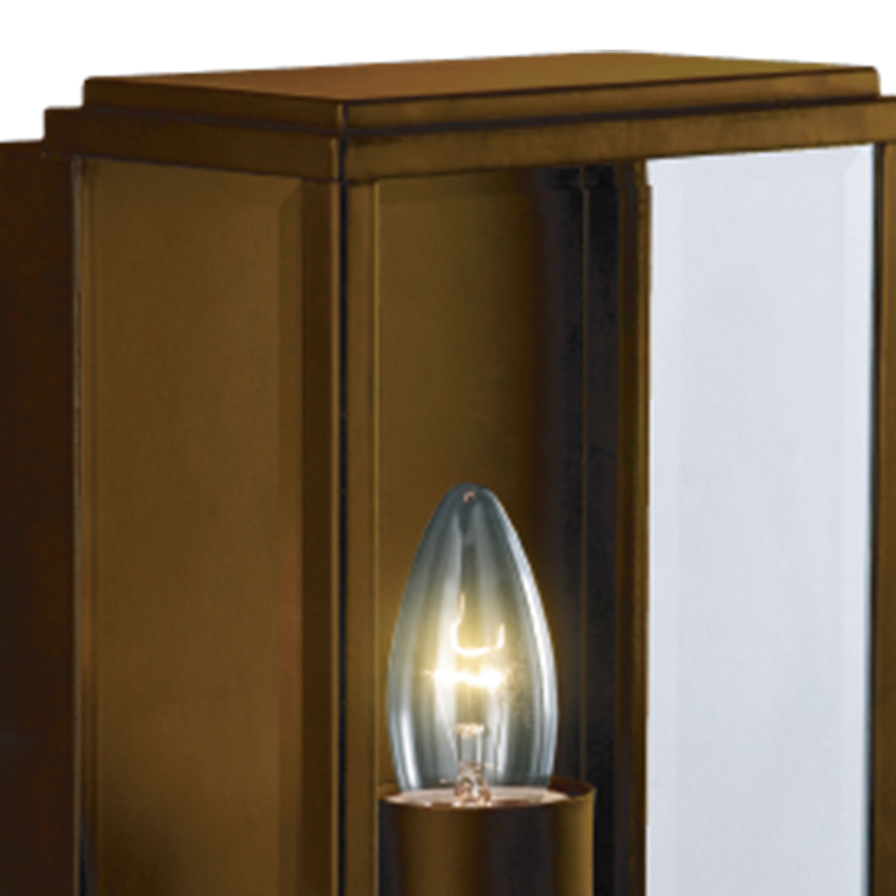 Close-up of a bronze outdoor wall light with a lit bulb.