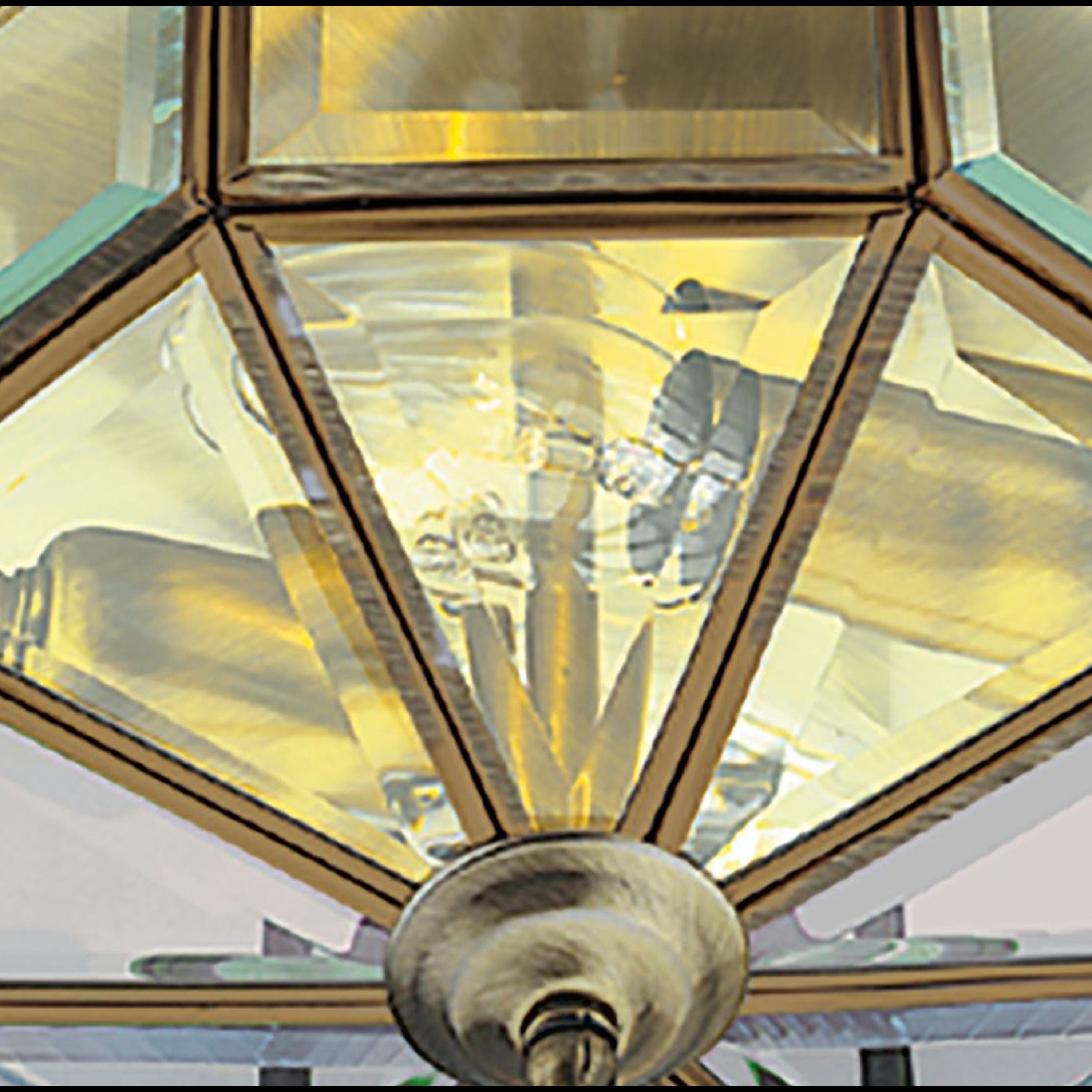 Close-up of the faceted glass and bronze frame of the octagonal ceiling light.