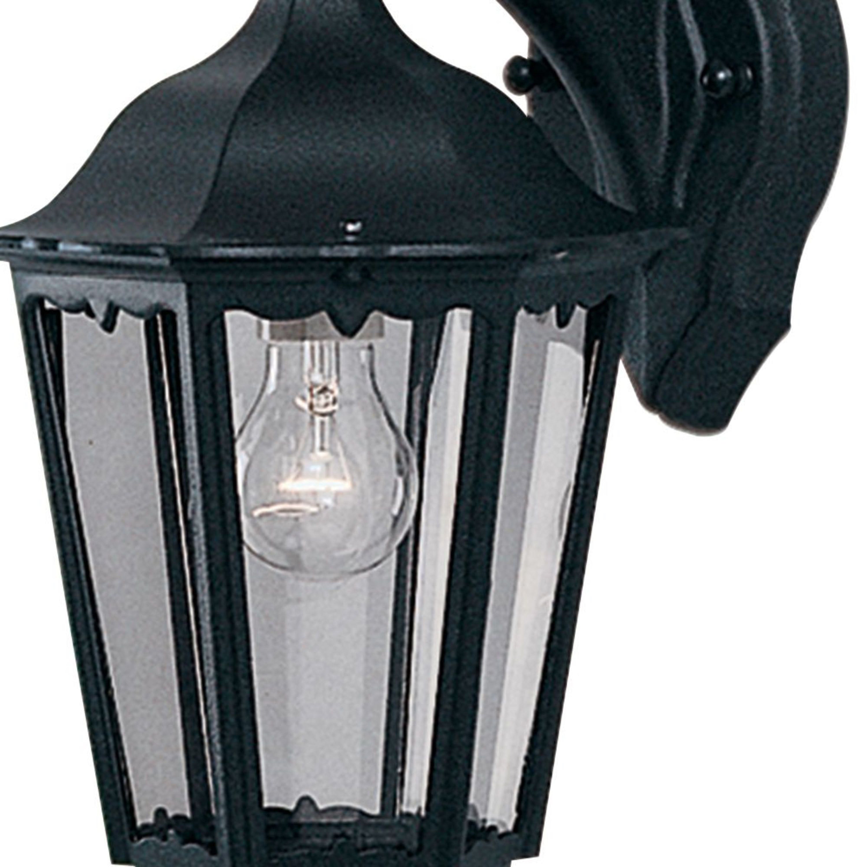 Close-up of a black outdoor wall lantern with a clear bulb, emphasizing details.