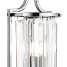 Detailed view of the chrome finish and crystal design on a wall-mounted light fixture.