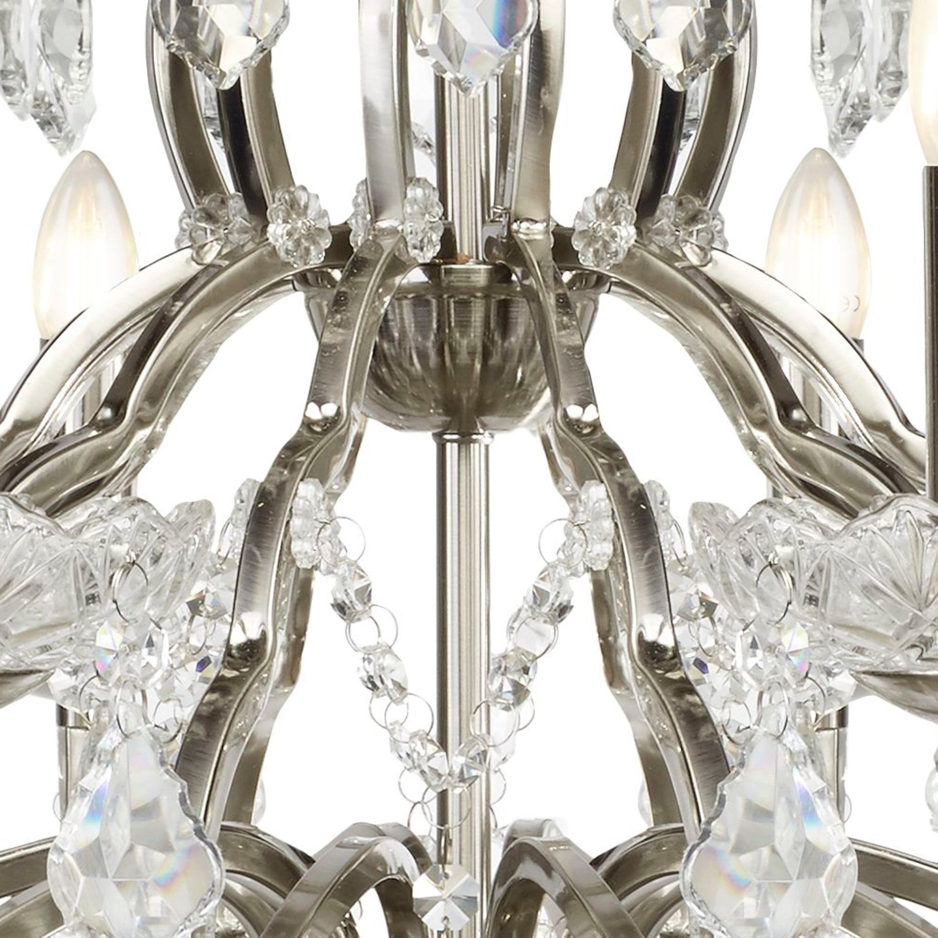Close-up of the brushed chrome and crystal details of a chandelier.