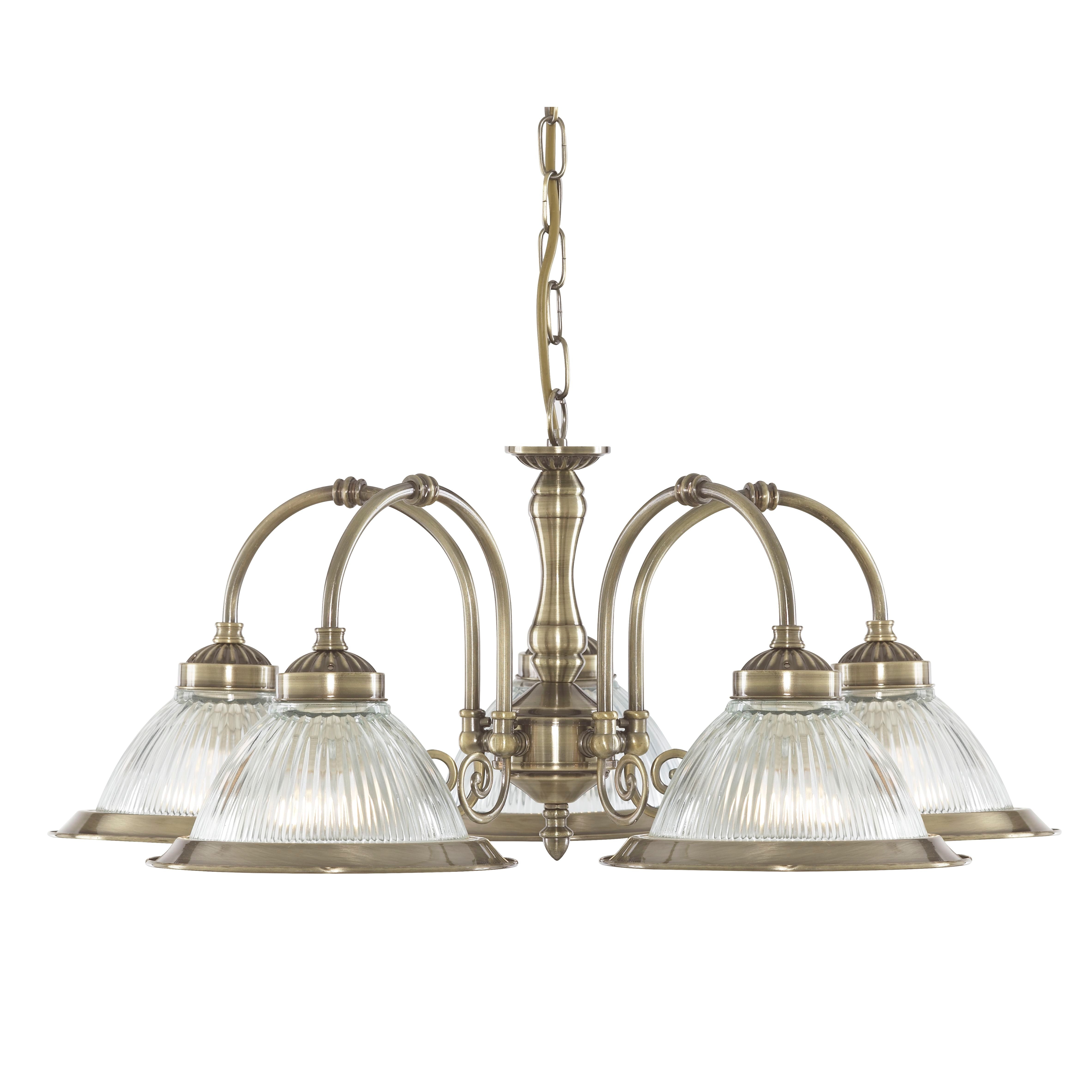 A five-light antique brass chandelier with ribbed glass shades.