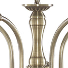 A close-up of the antique brass stem of a chandelier.