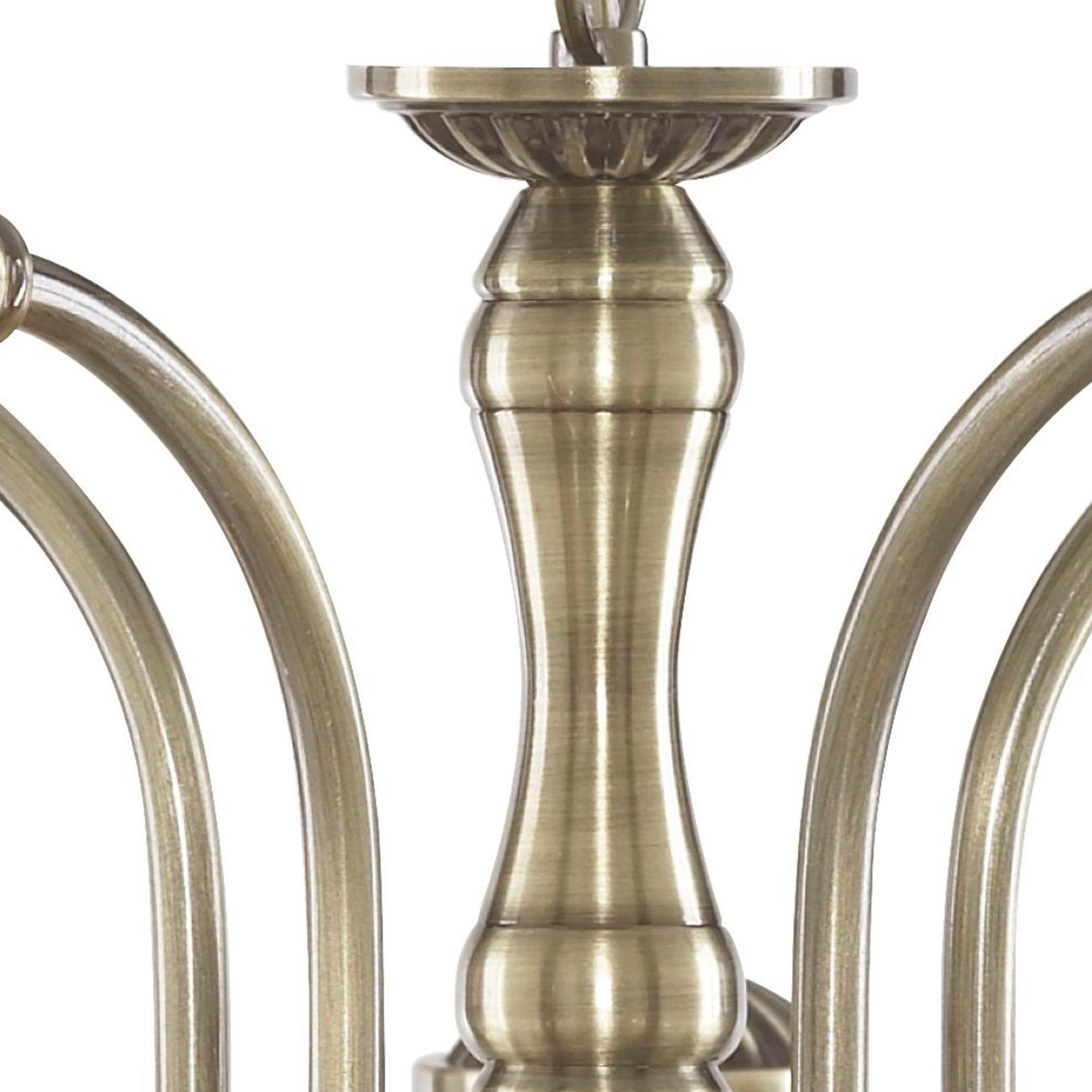 A close-up of the antique brass stem of a chandelier.