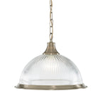 A clear ribbed glass dome pendant light with an antique brass fixture and chain.