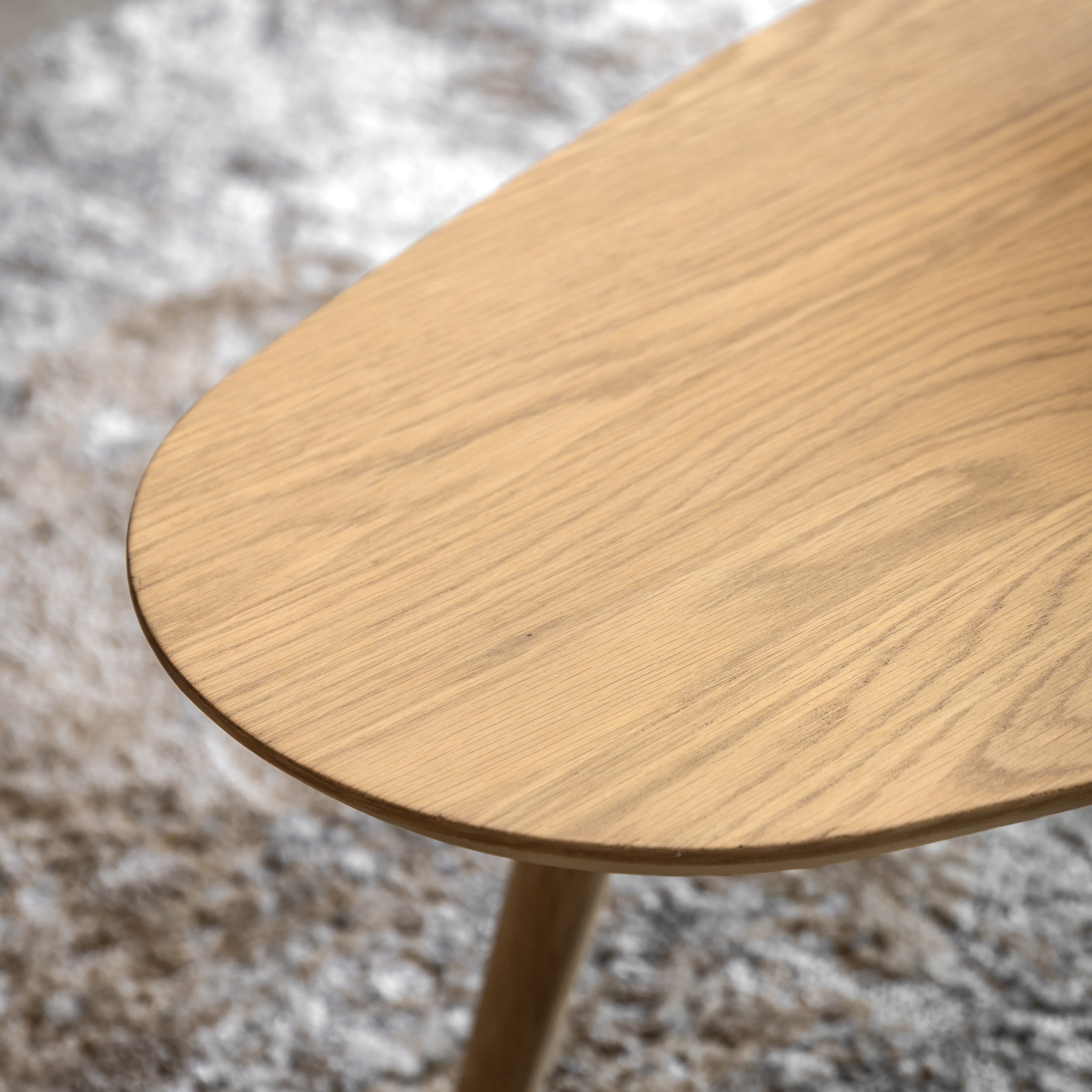 Close-up of the light wood grain on a contemporary coffee table, showcasing natural textures.