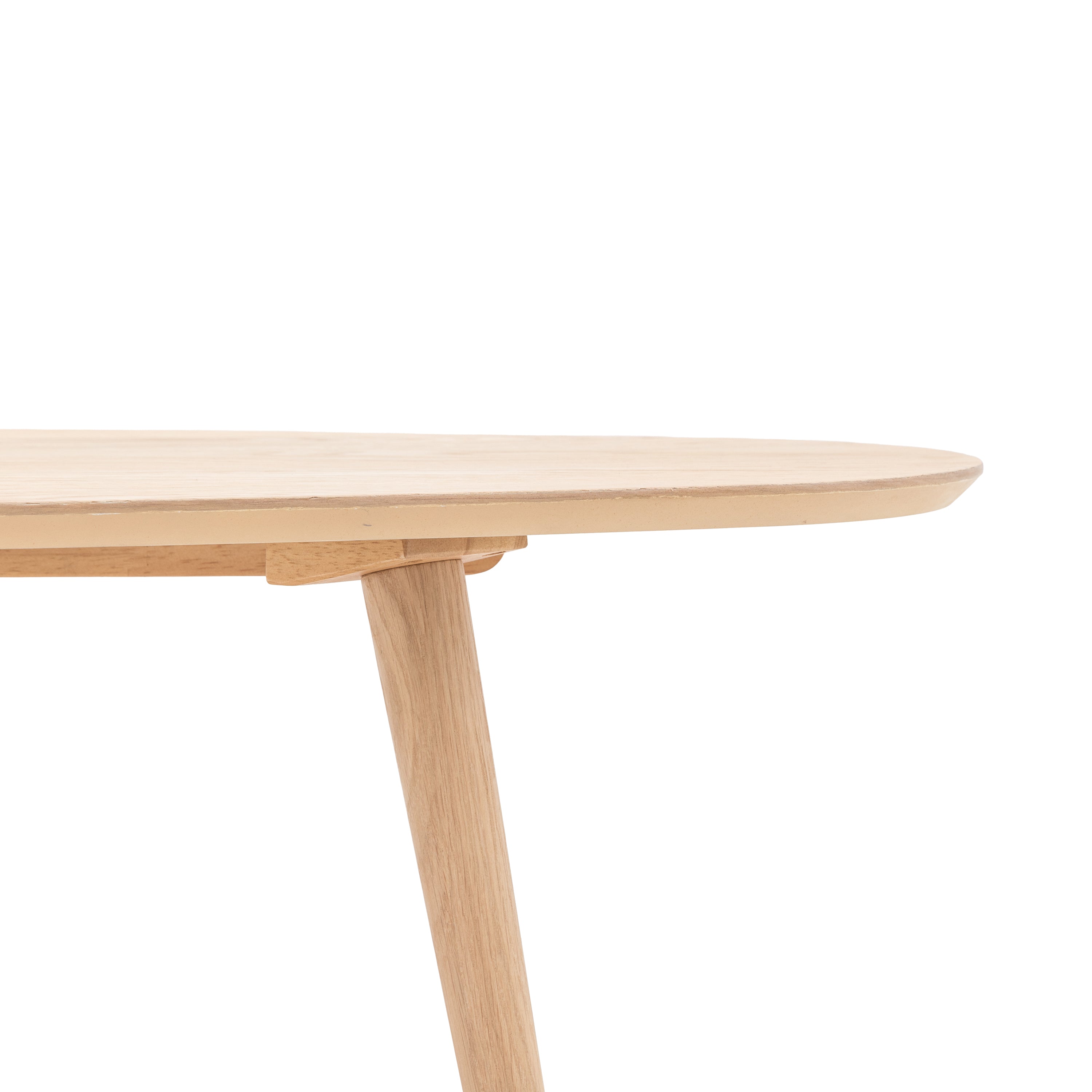 Close-up of the smooth, rounded edge of a light wooden table top and a tapered leg.