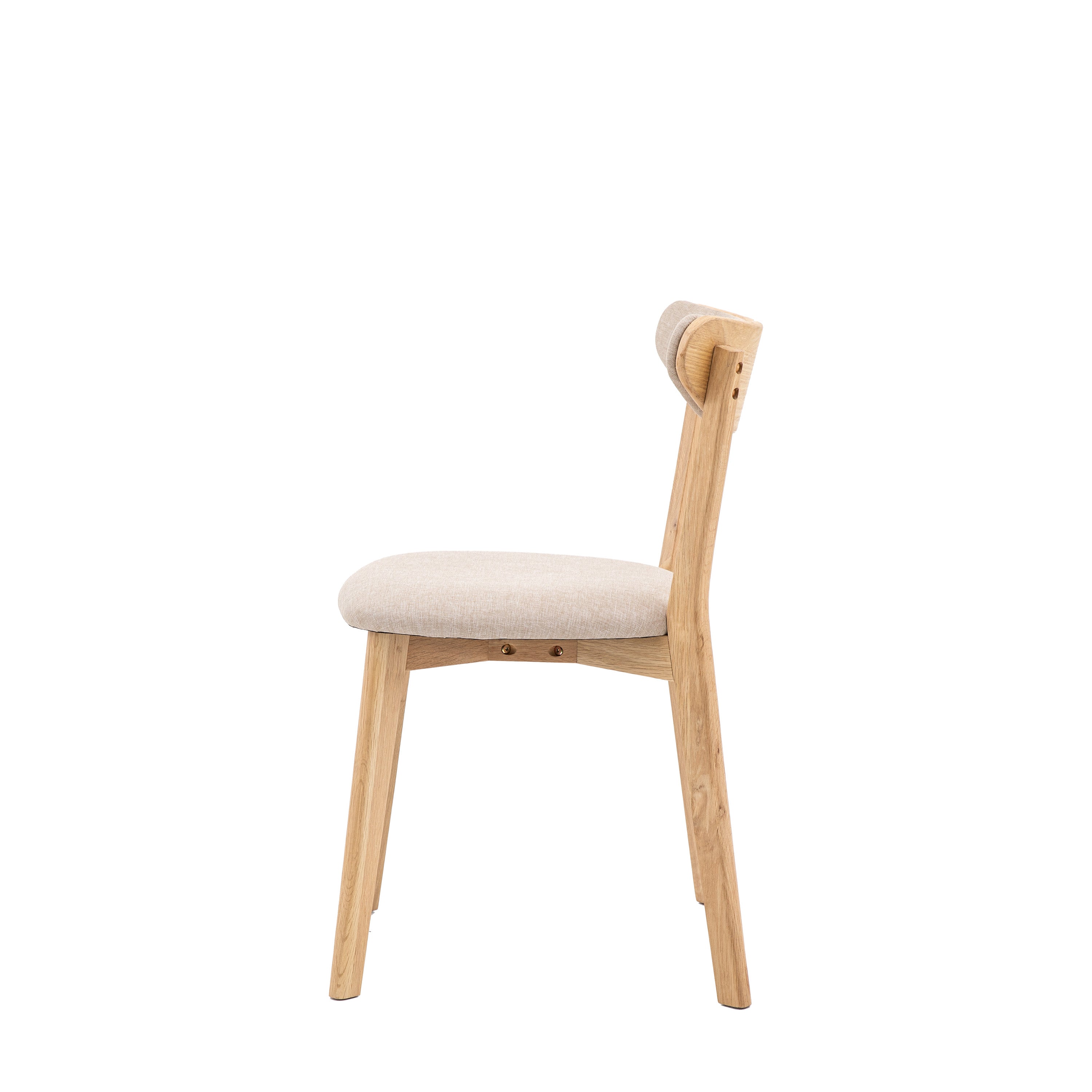 A side view of a light wood dining chair with a cream upholstered seat and back.
