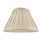 A cream pleated lamp shade.