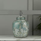 A decorative ginger jar lamp base with blue and green patterns.