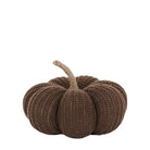 Brown knitted pumpkin with a natural stem on a white background, for charming autumn displays.
