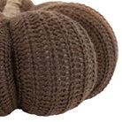 Close-up of the textured knit of a brown pumpkin, showcasing the ribbed design.