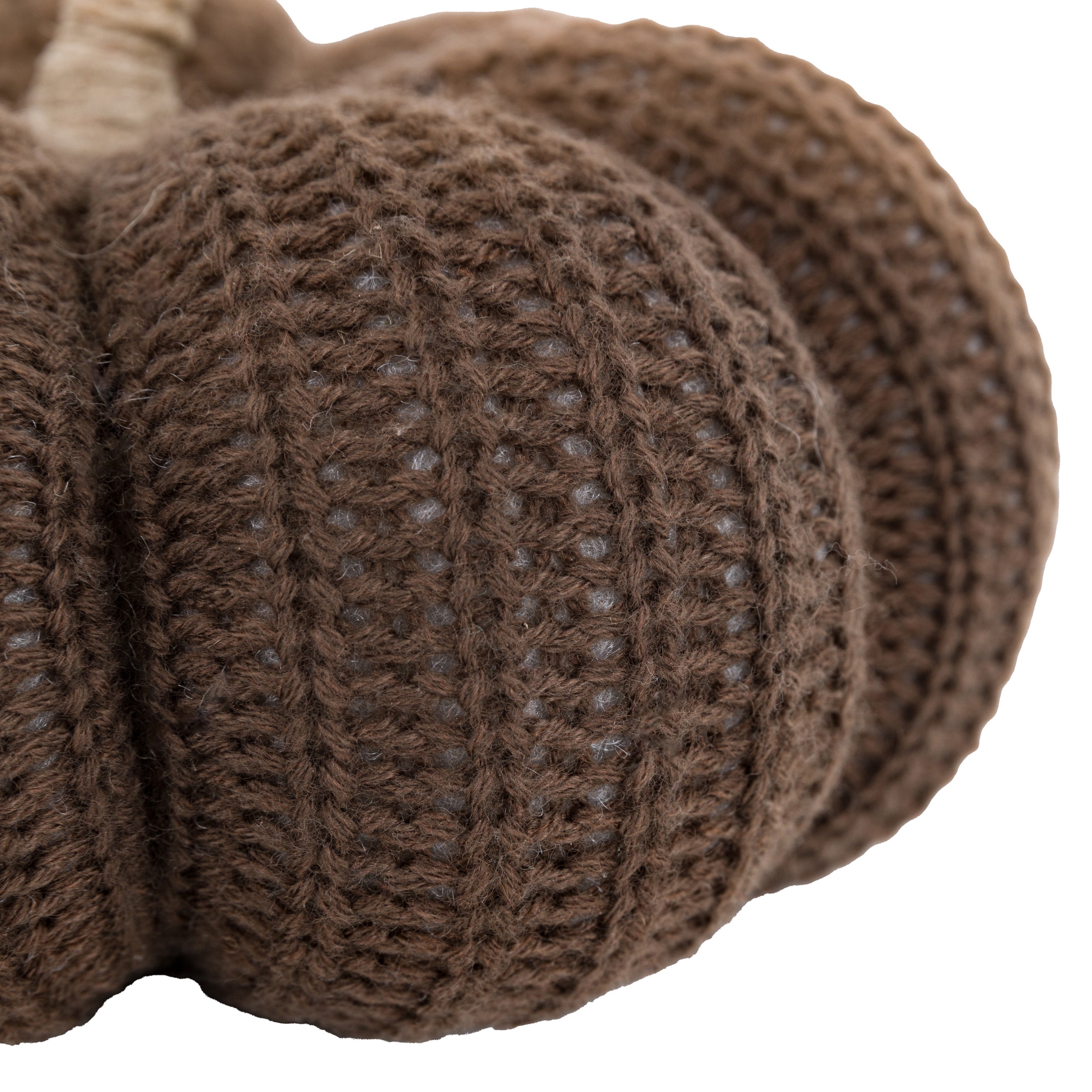 Close-up of the textured knit of a brown pumpkin, showcasing the ribbed design.
