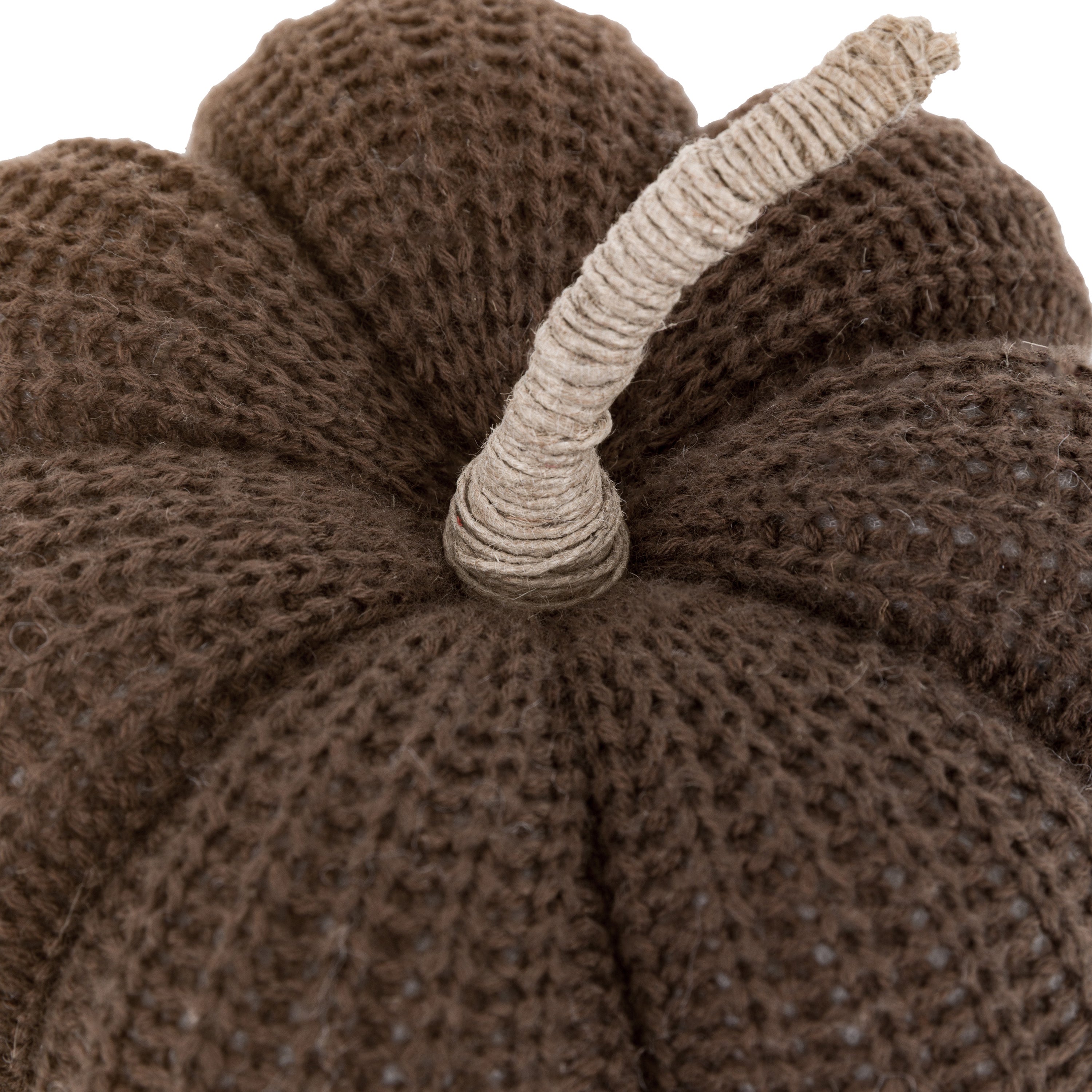 Top view close-up of a brown knitted pumpkin, highlighting its natural stem and texture.