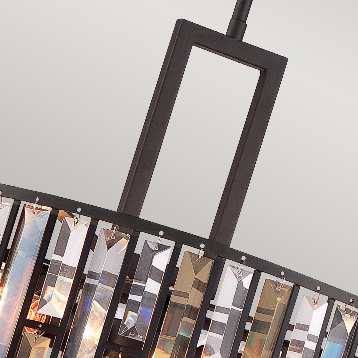 A close-up of the rectangular bronze frame and crystal detailing of the pendant light.