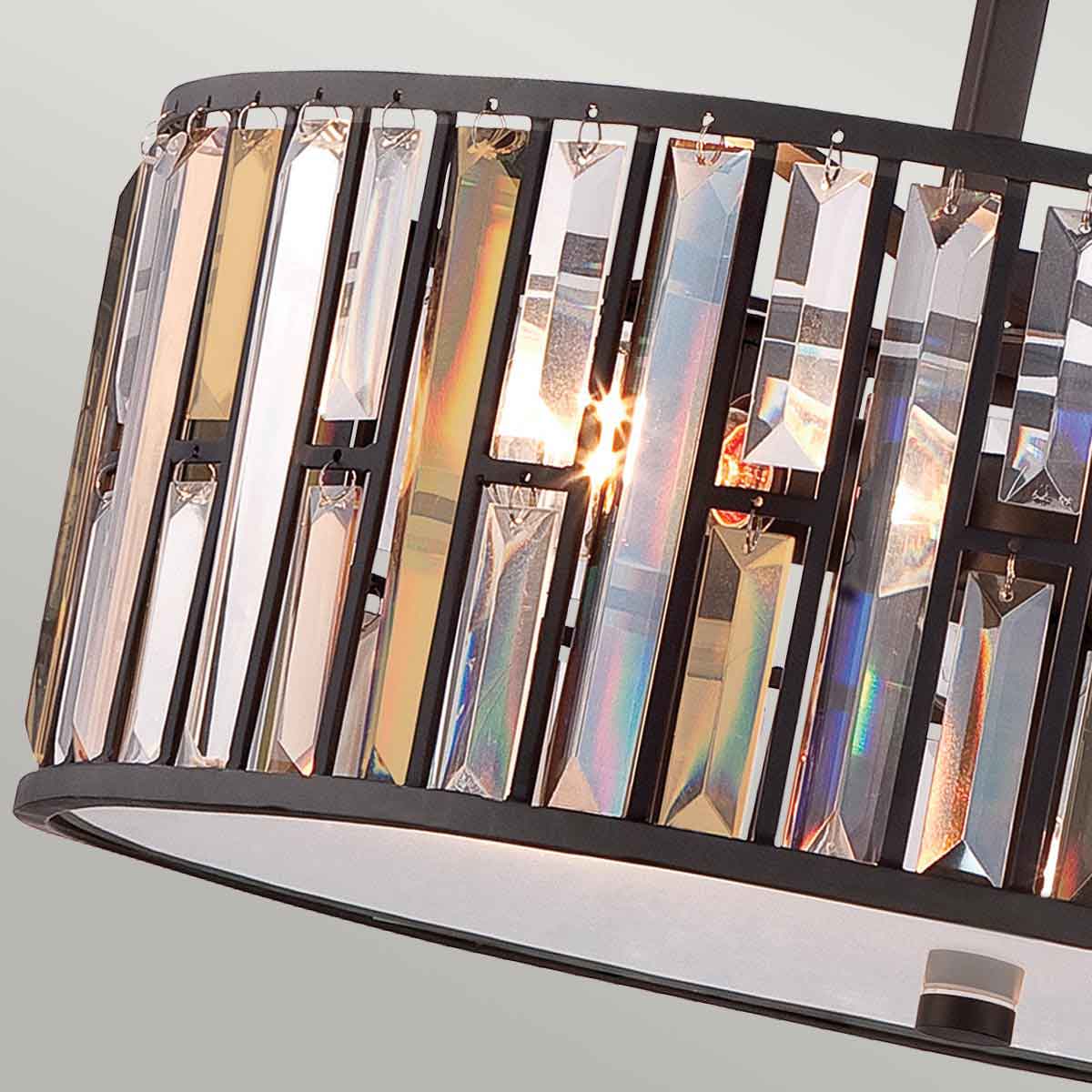 A close-up of the clear and amber crystal rods forming the shade of the pendant light.