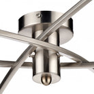 Detailed view of the central chrome fitting and crossed arms of the ceiling light.